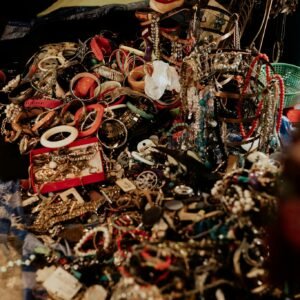 A close-up view of an array of vibrant jewelry pieces at a flea market. Ideal for vintage and fashion concepts.